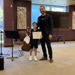 guitar level classical guitar teacher and guitar student holding a certificate