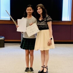 flute level flute teacher and flute student holding a certificate