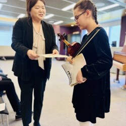 violin level violin teacher and violin student holding a certificate